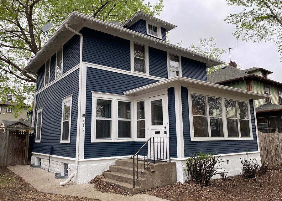 Two-storey stucco home after exterior repaint
